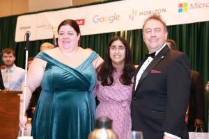 Trisha Kulkarni smiles brightly with Cayte Mendez and Mark Riccobono after receiving her scholarship award.